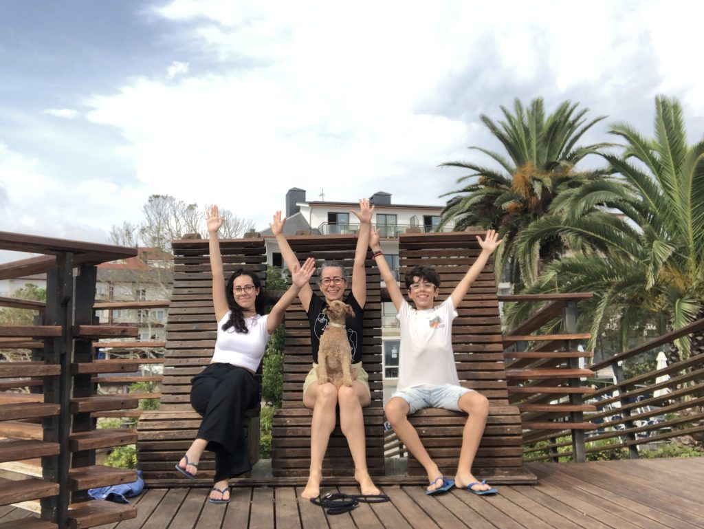 Julia Santafé with her two teenage children and dog celebrating being together during summer vacation