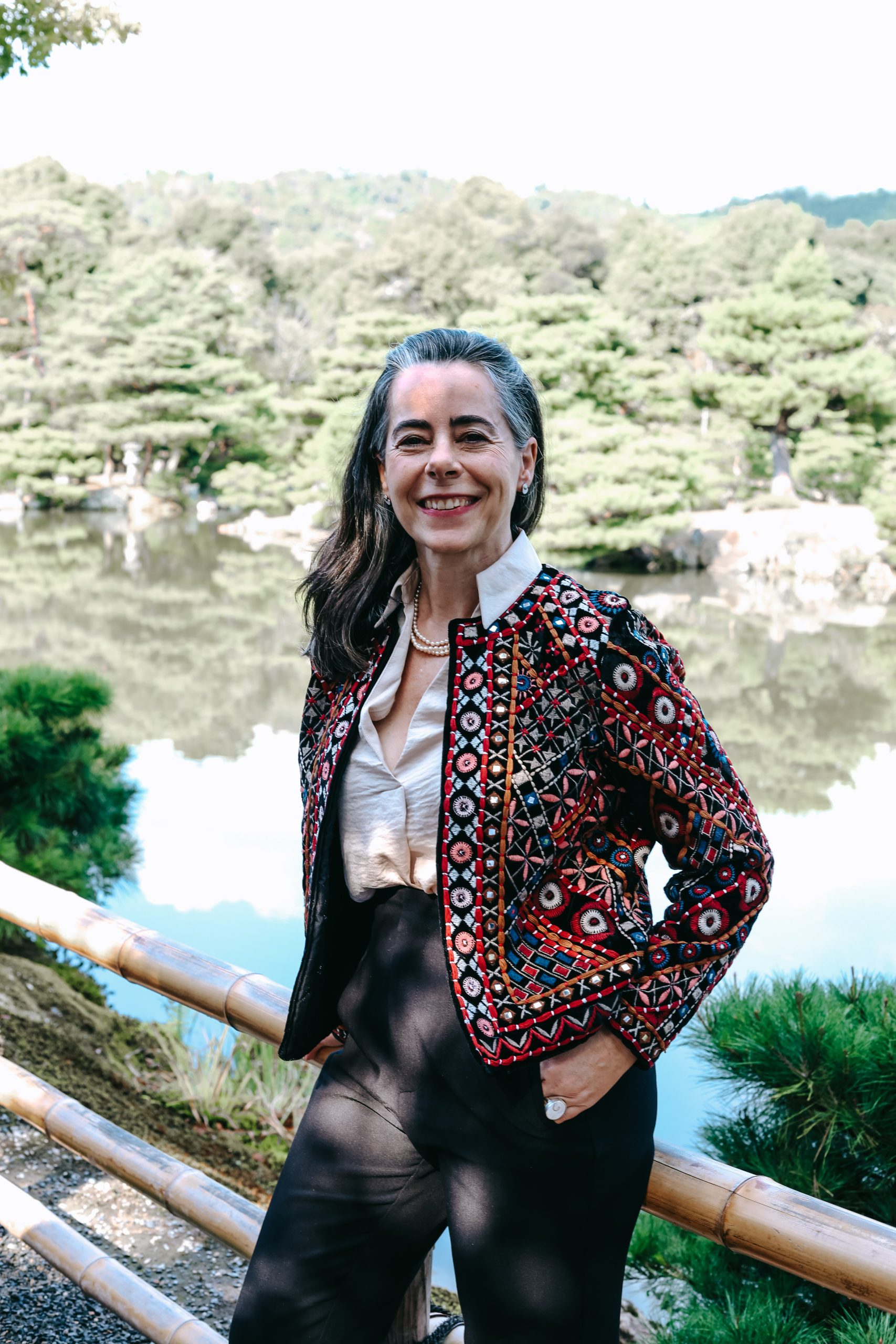 AN ELEGANT CONFIDENT WOMAN IN A RELAXED POSTURE SMILING